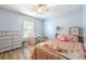 Bright bedroom featuring a ceiling fan, a window, and a charming vanity area at 626 Dover St, Marietta, GA 30066