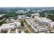 An aerial view of community homes and apartment buildings surrounded by lush green trees and roads at 1017 Brandsford Nw St, Atlanta, GA 30318