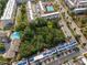 An aerial view of community homes with solar panels, community pools, lush trees, and roads at 1017 Brandsford Nw St, Atlanta, GA 30318