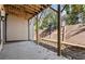 Wooded backyard featuring a small patio, wood retaining wall, and a privacy fence at 1017 Brandsford Nw St, Atlanta, GA 30318