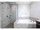 Modern bathroom featuring a glass-enclosed shower and soaking tub at 1017 Brandsford Nw St, Atlanta, GA 30318