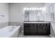 Bright bathroom featuring a double vanity and luxurious soaking tub at 1017 Brandsford Nw St, Atlanta, GA 30318