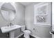 Elegant bathroom features a pedestal sink, modern fixtures, and ample natural light at 1017 Brandsford Nw St, Atlanta, GA 30318