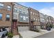 Charming exterior view of townhomes with brick and siding and attached garages at 1017 Brandsford Nw St, Atlanta, GA 30318