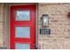 Eye-catching red front door with decorative glass panels and house number against a brick facade at 1017 Brandsford Nw St, Atlanta, GA 30318