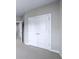 Hallway with double-door closet offers great storage with carpeted floors and neutral paint at 1017 Brandsford Nw St, Atlanta, GA 30318