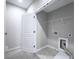 A functional laundry room with tile floors and washer and dryer hookups at 1017 Brandsford Nw St, Atlanta, GA 30318