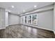 Bright, spacious living room with hardwood floors, gray walls, and large windows at 1017 Brandsford Nw St, Atlanta, GA 30318