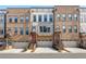 Charming brick townhomes feature attached garages and red front doors, offering modern urban living at 1017 Brandsford Nw St, Atlanta, GA 30318