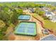 Aerial view of a neighborhood with tennis courts and houses at 15 Sweet Cane Ct, Grayson, GA 30017