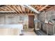 Unfinished basement with cinder block walls, windows and a door to outside at 2601 Round Ridge Rd, Loganville, GA 30052