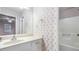 Clean bathroom featuring classic wallpaper, and a large mirror for a bright, open feel at 2601 Round Ridge Rd, Loganville, GA 30052