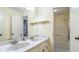 Bathroom features a double sink vanity with a large mirror and a view to a shower and tub at 2601 Round Ridge Rd, Loganville, GA 30052