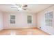 Comfortable bedroom featuring wood flooring, soft paint color, and bright windows at 2601 Round Ridge Rd, Loganville, GA 30052