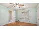Bedroom with light green walls, hardwood floors, and a bathroom with a shower and tub at 2601 Round Ridge Rd, Loganville, GA 30052