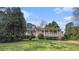 Charming single-story home with a cozy front porch nestled amongst lush greenery on a well-maintained lawn at 2601 Round Ridge Rd, Loganville, GA 30052