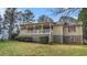 Charming home showcasing an inviting, spacious porch, complemented by red shutters on the windows at 2601 Round Ridge Rd, Loganville, GA 30052