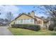 Exterior view of the home with attached garage; side of home has a set of windows for natural light at 2601 Round Ridge Rd, Loganville, GA 30052