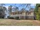 Traditional home with a spacious front porch, brick foundation and lush landscaping providing a welcoming entrance at 2601 Round Ridge Rd, Loganville, GA 30052