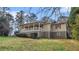 Single-story home with inviting porch is accentuated by a gentle slope and mature landscaping on a sunny day at 2601 Round Ridge Rd, Loganville, GA 30052