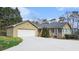 View of the home's exterior with an attached garage; side of home has a set of windows for natural light at 2601 Round Ridge Rd, Loganville, GA 30052