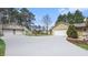 View of the home's exterior and detached garages; one with an upstairs balcony, the other attached to the home at 2601 Round Ridge Rd, Loganville, GA 30052