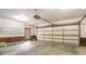 Spacious garage featuring an automatic door, utility door, wainscoting, and ample room for storage and vehicle parking at 2601 Round Ridge Rd, Loganville, GA 30052