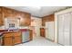 Well-maintained kitchen with wood cabinets, stainless steel dishwasher, and durable countertops at 2601 Round Ridge Rd, Loganville, GA 30052