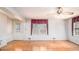 Bright living room with hardwood floors, white walls, and large windows offering great natural light at 2601 Round Ridge Rd, Loganville, GA 30052
