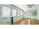 Bright sunroom featuring hardwood floors and multiple windows for ample sunlight at 2601 Round Ridge Rd, Loganville, GA 30052