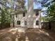 An inviting backyard features a concrete patio, wood fence, and mature trees providing shade and privacy at 3227 Diamond Blf, Union City, GA 30291
