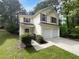 Charming two-story home featuring a two-car garage and manicured landscaping at 3227 Diamond Blf, Union City, GA 30291