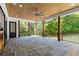 Spacious covered patio with wood ceilings, flagstone flooring, and wooded views at 1645 Mayfield Rd, Alpharetta, GA 30009