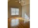 Hardwood floor bedroom with large window and ceiling fan at 89 Grand Oak Way, Dallas, GA 30157