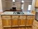 Large kitchen island with granite countertop and gas cooktop at 89 Grand Oak Way, Dallas, GA 30157