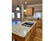 Granite kitchen island with gas cooktop, open to Gathering room at 89 Grand Oak Way, Dallas, GA 30157