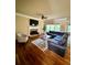 Spacious living room with hardwood floors, fireplace, and large windows at 89 Grand Oak Way, Dallas, GA 30157