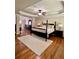 Main bedroom with hardwood floors and large bed at 89 Grand Oak Way, Dallas, GA 30157