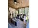 Relaxing screened porch with comfy seating and lovely curtains at 89 Grand Oak Way, Dallas, GA 30157