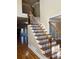 Elegant staircase with wrought iron balusters and hardwood treads at 89 Grand Oak Way, Dallas, GA 30157