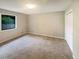 A clean and airy bedroom features plush carpeting, a window, and a closet for ample storage at 3551 Mill Glen Dr, Douglasville, GA 30135