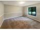 A clean, carpeted bedroom with natural light and a neutral color palette provides a cozy feel at 3551 Mill Glen Dr, Douglasville, GA 30135