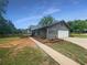 Charming single-story home with attached garage and well-maintained lawn and a paved walkway at 3551 Mill Glen Dr, Douglasville, GA 30135