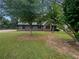 Beautiful home with stone accents and mature trees offering shade and curb appeal to the property at 3551 Mill Glen Dr, Douglasville, GA 30135