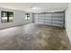 Clean, spacious garage with modern lighting, newly painted white walls and concrete flooring at 3551 Mill Glen Dr, Douglasville, GA 30135