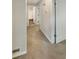 A carpeted hallway with neutral walls leads to additional rooms and storage space at 3551 Mill Glen Dr, Douglasville, GA 30135
