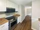 Updated kitchen with modern appliances, stainless steel oven, white cabinets and wood style floors at 3551 Mill Glen Dr, Douglasville, GA 30135
