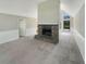 Spacious living room featuring a stone fireplace, neutral walls, plush carpet, and a high ceiling at 3551 Mill Glen Dr, Douglasville, GA 30135
