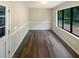 Cozy bonus room featuring neutral walls, wainscoting, a large window, and modern wood floors at 3551 Mill Glen Dr, Douglasville, GA 30135