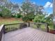 Enjoy tree-filled backyard views from the deck area with wood railing at 277 Players Cir, Fayetteville, GA 30215